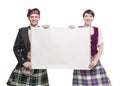 Pair of dancers of Scottish dance with empty banner Royalty Free Stock Photo