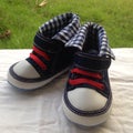 Pair of dark blue sporty for kid shoes nature background