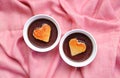 Pair of Dark Chocolate Mousse with Heart Shaped Chiffon Cakes on Pink Drapery Cloth Royalty Free Stock Photo