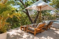 Pair of deckchairs with canopy next to swimming pool at luxury resort Royalty Free Stock Photo