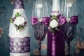 A pair of decorative purple champagne bottles and glasses for the bride and groom Royalty Free Stock Photo