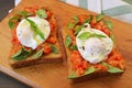 Pair of Delectable Fresh Tomato and Basil Toast Topped with Poached Egg