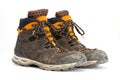 Pair of dirty brown/orange men`s hiking boots with white background. Royalty Free Stock Photo