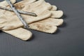 Pair of dirty textile protective gloves for repair or other hard works near old messy drills