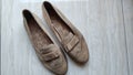 a pair of suede women shoe in cream color which is very dusty and dirty, top view photo angle