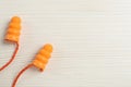 Pair of ear plugs on white wooden background  flat lay. Space for text Royalty Free Stock Photo