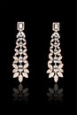 Pair of Earrings with diamonds isolated over black