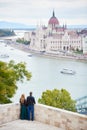 Pair is enjoying view of Danube River, Parliament Building. Budapest Royalty Free Stock Photo