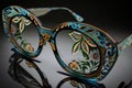 pair of eyeglasses with intricate, hand-painted design