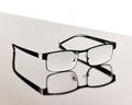 Pair of eyeglasses placed on a reflective tabletop Royalty Free Stock Photo