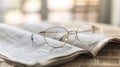 A pair of eyeglasses rests on an open book, the blurred background emphasizing the simplicity of the scene. Generative Royalty Free Stock Photo