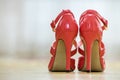 Pair of fashionable high heel leather red cut-out female shoes with golden buckles isolated on light copy space background. Style Royalty Free Stock Photo