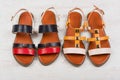 Pair of fashionable women`s sandals on white wooden background Royalty Free Stock Photo