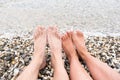 Pair of feet on the beach. Legs of a man and a woman on the sea. Loving couple on vacation. Travel to the ocean. Royalty Free Stock Photo