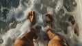 A pair of feet submerged in the warm foamy water of a hot tub toes wiggling in delight Royalty Free Stock Photo