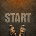 A pair of feet on a tarmac road with white print of the word sta Royalty Free Stock Photo