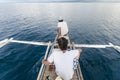 A pair of fishermen return home on a small motorized outrigger boat, known locally as a bangka, after fishing in the open sea. In