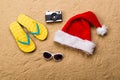 Pair of flip flop sandals, sunglasses, Santa hat and camera. Royalty Free Stock Photo