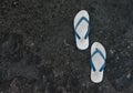 A pair of flip flops or slippers with blacl texture and abstract pattern roof background Royalty Free Stock Photo