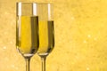 A pair of flutes of champagne golden abstract background