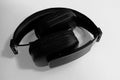 A pair of folded black on-ear wireless headphones on white background Royalty Free Stock Photo