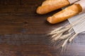 Pair of french bread loaves and wheat stalks Royalty Free Stock Photo