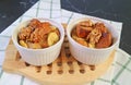 Pair of Fresh Baked Banana Bread Pudding in Ceramic Bowls on Wooden Breadboard