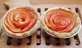 Pair of Fresh Baked Homemade Mini Apple Rose Tartlets on Wooden Breadboard