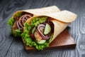 Pair of fresh juicy wrap sandwiches with chicken and vegetables