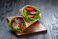 Pair of fresh juicy wrap sandwiches with chicken and vegetables