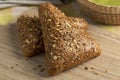 Pair of fresh multi grain buns on a cutting board close up