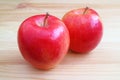 Pair of fresh red apple isolated on wooden table