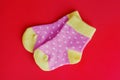 Pair of funny colorful dotted pink and yellow baby socks