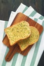 Pair of Garlic Butter Toasts on Wooden Breadboard on Wooden Table