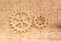 Pair of gears on the assembled group of puzzles Royalty Free Stock Photo