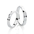 Pair of geometric silver wedding rings with diamond isolated on white background