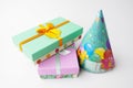 Pair gift paper cardboard boxes, bow, stack holiday caps. White background. Birthday party concept Royalty Free Stock Photo