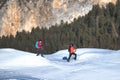 Pair of girls walks on snow with mountaineering equipment