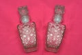 A pair of glass fluid bottles with floral patterns Royalty Free Stock Photo