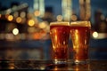 A pair of glasses of beer sitting on a table, high quality, high resolution Royalty Free Stock Photo