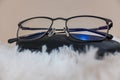 A pair of glasses with a black frame on a black box Royalty Free Stock Photo