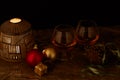 Pair of glasses of liquor on decorated Christmas table with candle lamp and black background Royalty Free Stock Photo