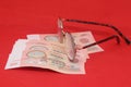 Pair of glasses and money on a red background. Selective focus.. Old banknotes of the former Soviet Union. USSR - rubles Royalty Free Stock Photo