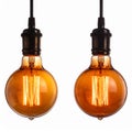 Pair of Glowing Amber Light Bulbs Against White Backdrop Royalty Free Stock Photo