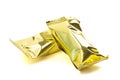 Pair of Gold Foil Wrapped Chocolate Truffles Isolated on a White Background Royalty Free Stock Photo