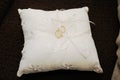 Pair of gold rings on a small white cloth cushion