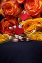 Pair of gold wedding rings and a bouquet of roses Royalty Free Stock Photo