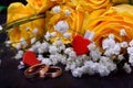 Pair of gold wedding rings and a bouquet of roses Royalty Free Stock Photo