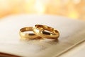 Pair of gold wedding rings on a prayer book Royalty Free Stock Photo