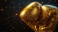 Pair of golden boxing gloves, reflecting light against a dark background. Concept of victory and success in sports